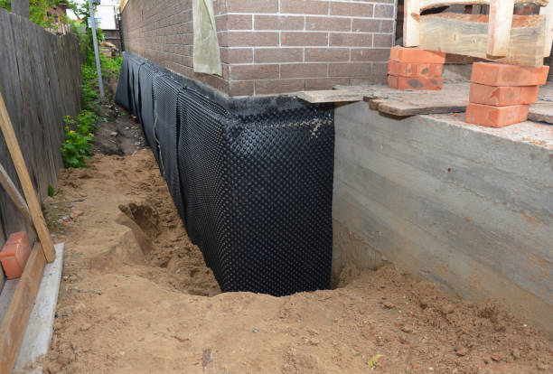 Happy homeowners after waterproofing job in Fenton